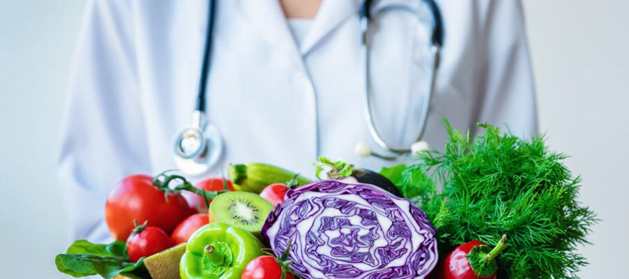 Doctor holding a bowl of fresh vegetables