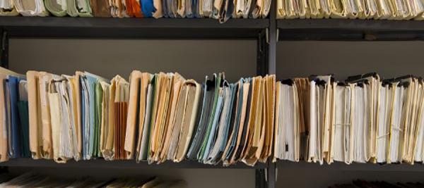 Hospital Administration Oral History Collection. Archive shelves with file folders filled with documents.