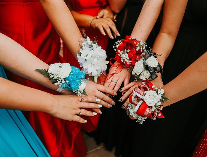 Girls hands showing prom corsages