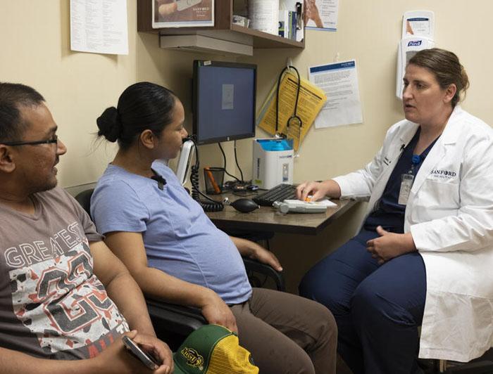 Elizabeth Brown, Sanford Health physician, speaks with a patient in her office