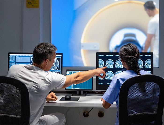 Stock image of clinicians reviewing MRI images