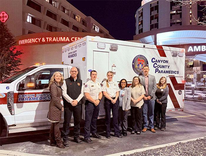 The Canyon County EMS whole-blood transfusion team stands in front of a Canyon County Paramedics ambulance 