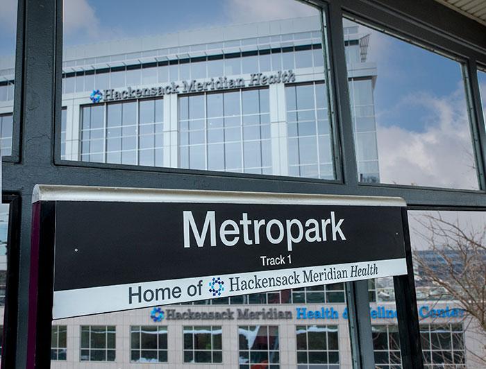 Metropark rail station sign featuring Hackensack Meridian Health logo