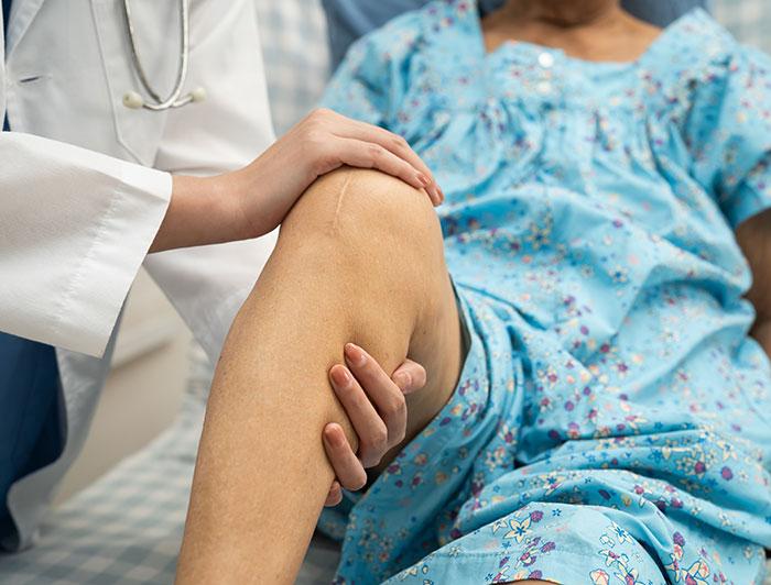 image of a health worker examining a patient's knee