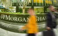 Latest Morgan Health Investments Signal the Company’s Focus. Pedestrians walk by a urban building with a JPMorgan Chase Company sign in front of it.