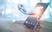 5 Key Telehealth Insights. A table stands on a tabletop with a physician's hand holding the bell of a stethoscope emerging from the screen via a telehealth app.