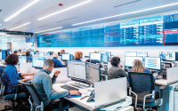 How Hospital Command Centers Streamline Patient Flow: 5 Proven Strategies. A group of hospital analysts sit in a hospital command center overseeing operations.