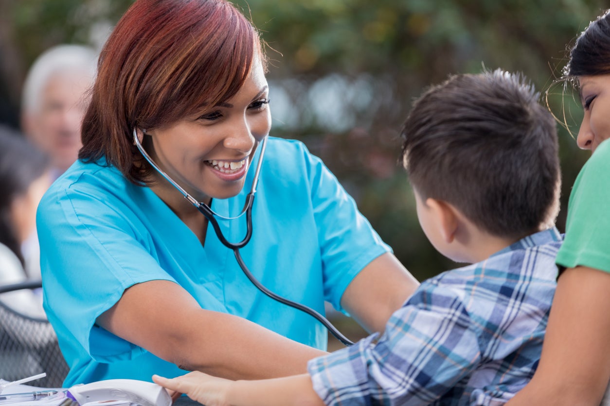 female nurse with stethoscope on child